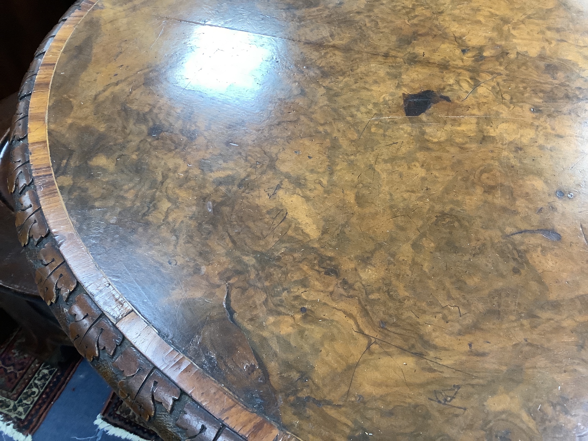 A Victorian oval tulip banded burr walnut centre table, width 104cm, depth 66cm, height 70cm